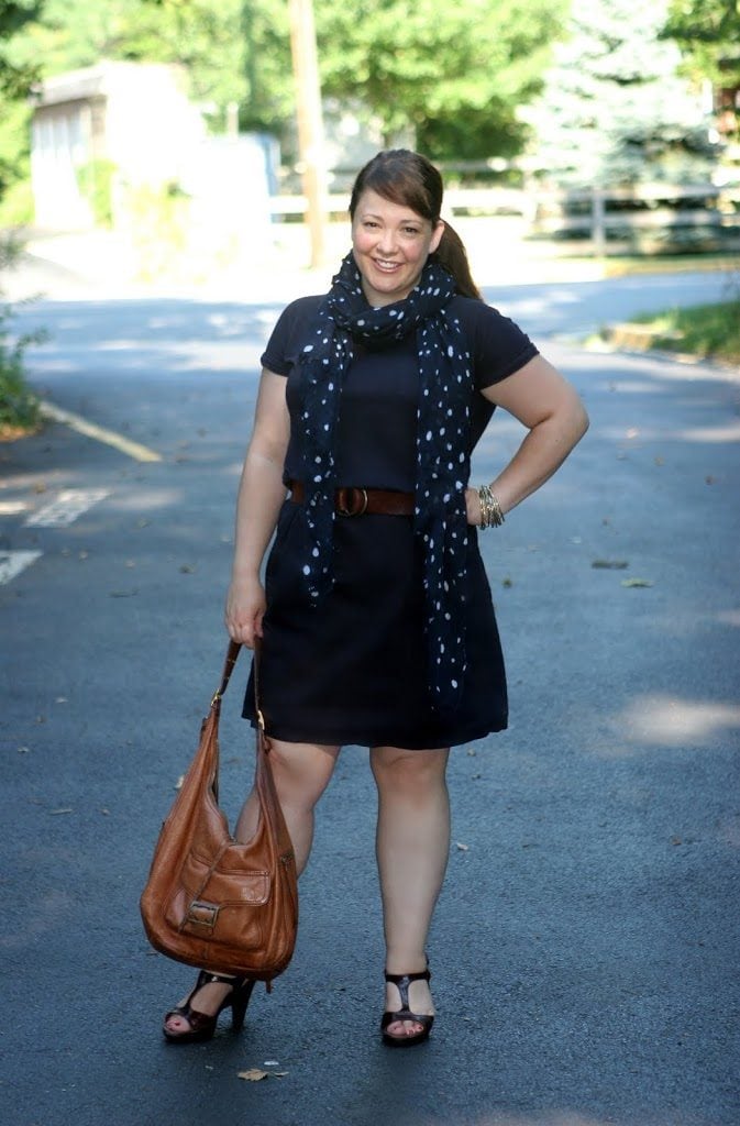 Alison Gary of Wardrobe Oxygen in a navy poplin dress from Lands' End Canvas holding a Banana Republic Sandhurst Hobo bag in camel leather