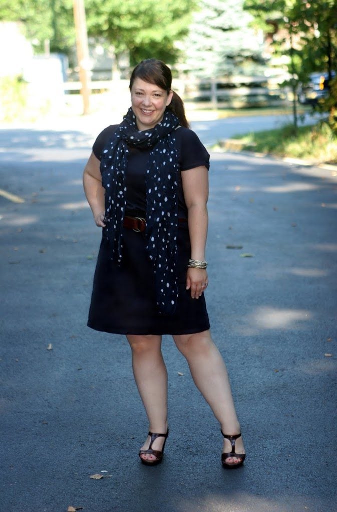 Alison Gary of Wardrobe Oxygen in a navy poplin dress from Lands' End Canvas holding a Banana Republic Sandhurst Hobo bag in camel leather