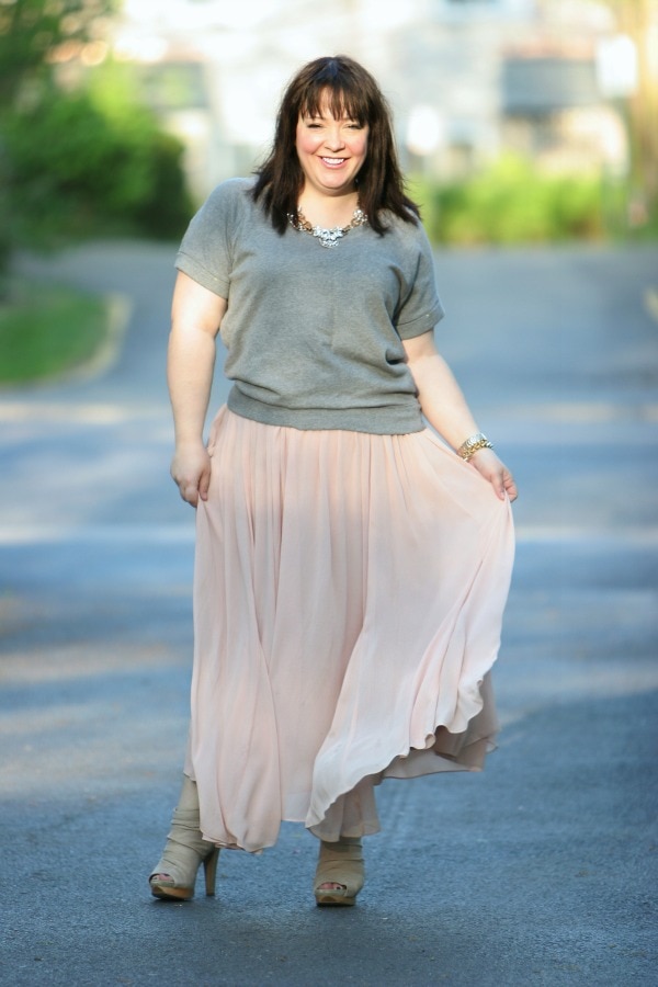 woman in a short sleeved gray sweatshirt and a blush pink maxi length ballerina skirt from Ann Taylor