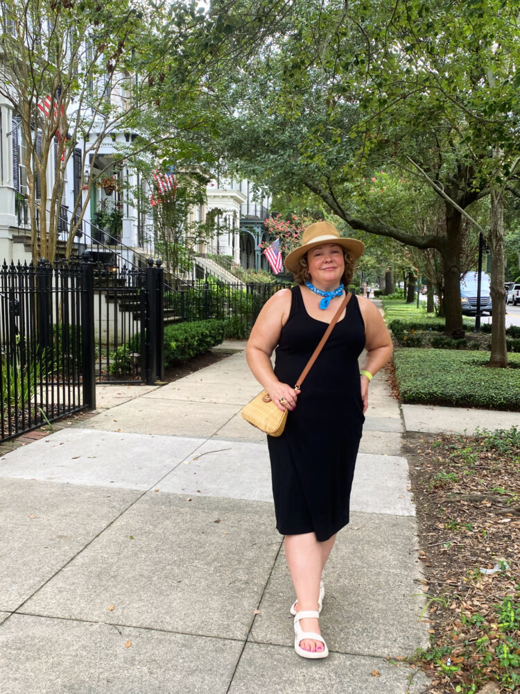 how to wear black in the summer featuring a black knit tank dress with tan accessories on Alison Gary of Wardrobe Oxygen