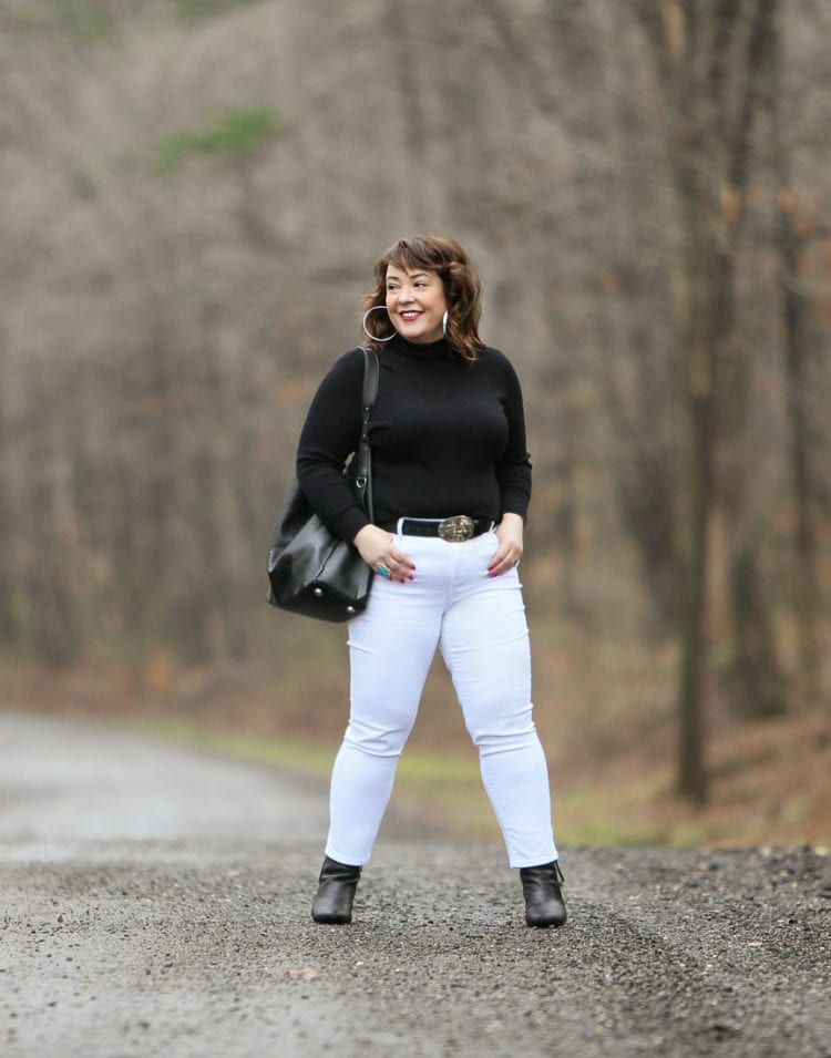 Black Coolmax turtleneck and white stain resistant jeans from Chico's styled on Wardrobe Oxygen with black Clarks ankle boots and the ALLSAINTS North/South tote