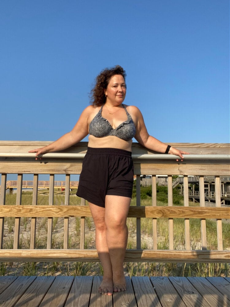 Alison Gary of Wardrobe Oxygen in black pull-on shorts and a black and white print bikini top