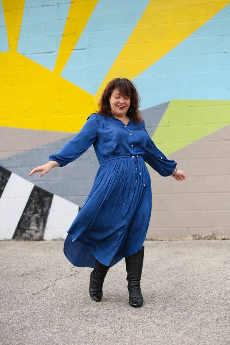Alison in a long sleeved blue silky drawstring waist shirtdress from Chico's.