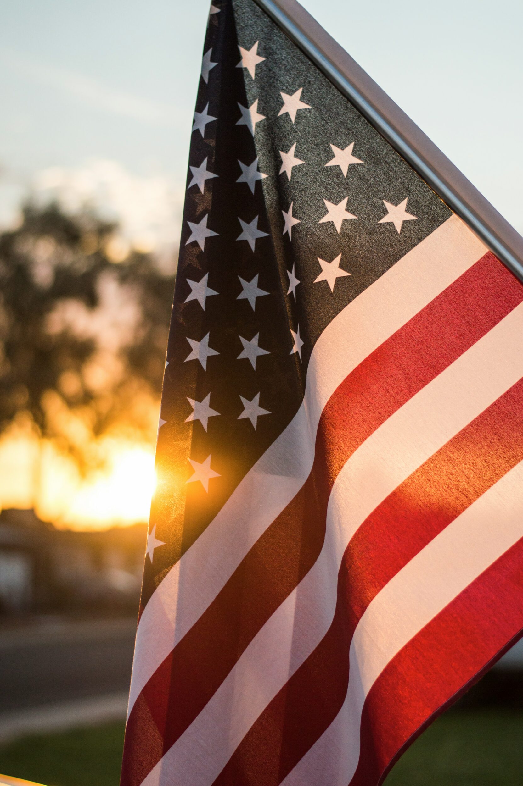 an american flag flying at sunset | May Day