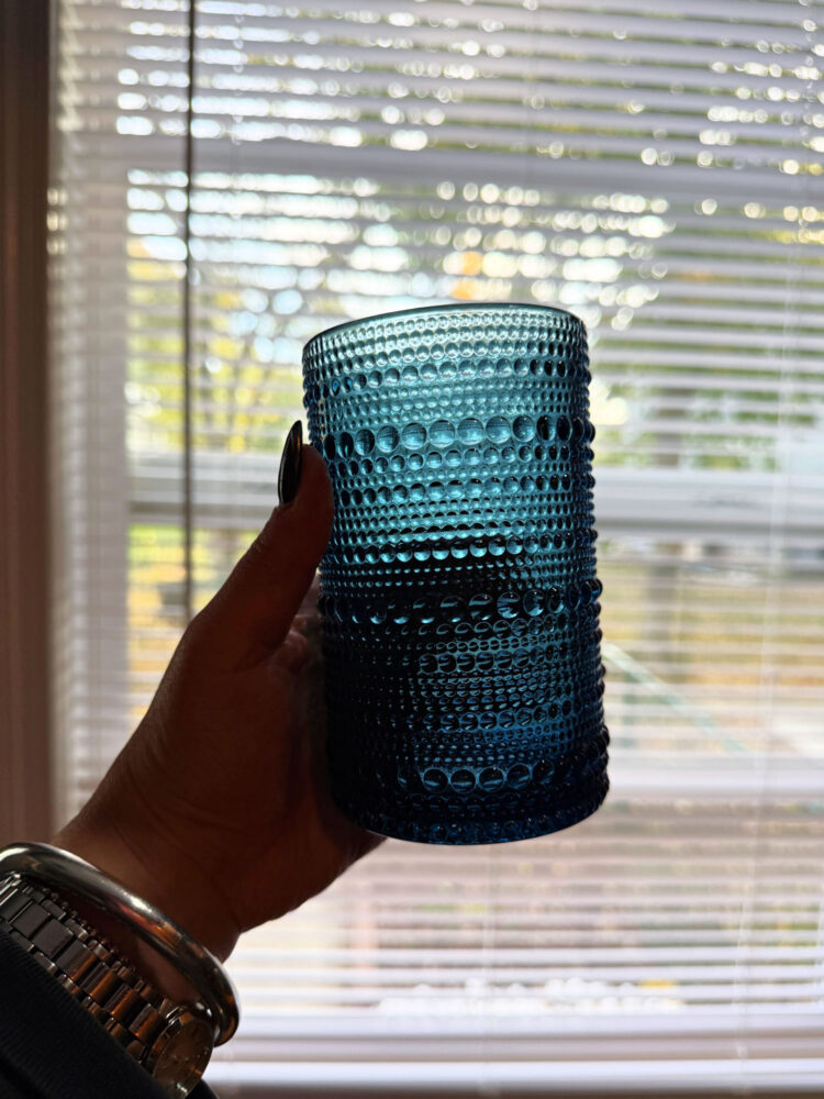 a hand holding a blue quince jupiter tumbler 