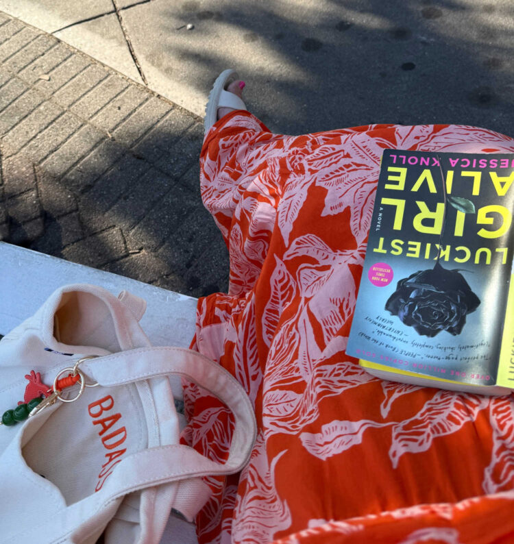 woman's lap holding the book luckiest girl alive | 2025 Rehoboth Beach