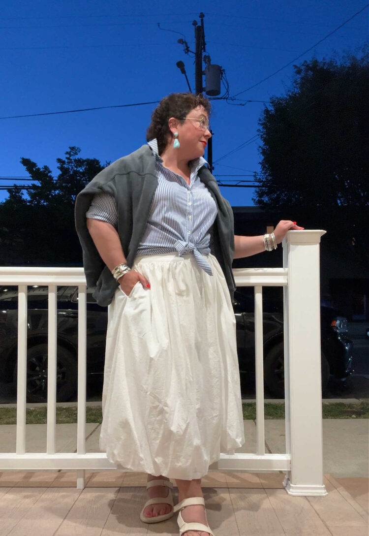 Alison in a white poplin bubble midi skirt and blue and white striped shirt tied at the waist