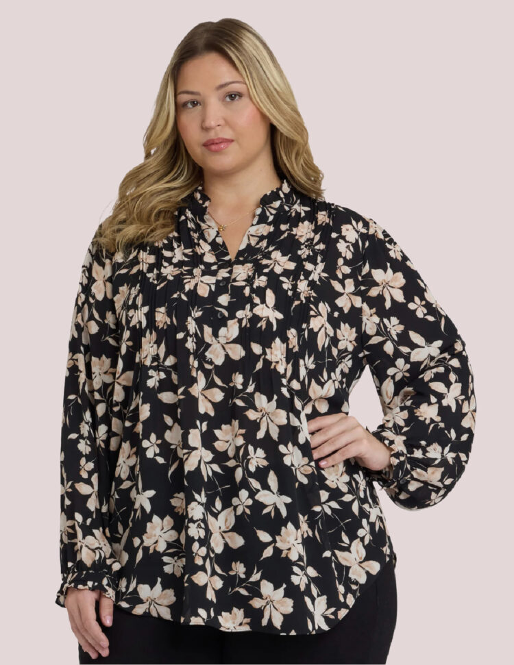 plus size model wearing the NYDJ silky tunic blouse in a black and beige floral print