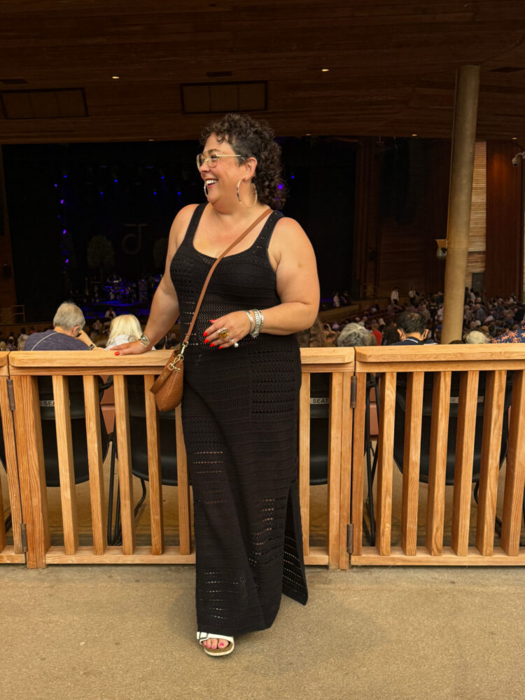 Woman in a black crocheted maxi dress and crossbody bag at Wolf Trap to see Jacob Collier in 2025